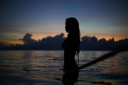 Silhouette of beauty girl in sunset, Philippine Islands, sunset reflection in Water Seaの写真素材