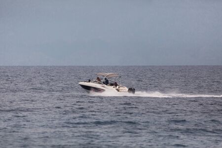 Speed boat in the open blue sea with back wash a seascape photography with copy spaceの写真素材