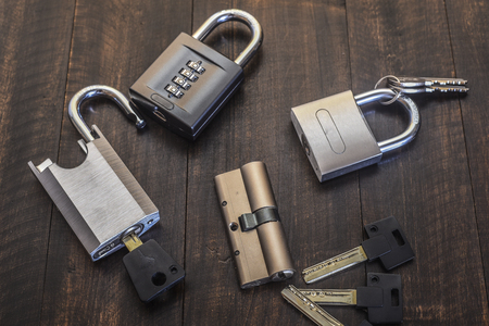 A new lock with keys on a wooden table.Top view.
