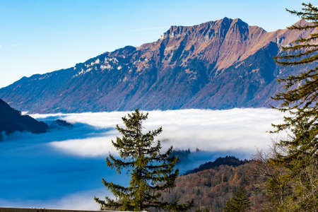 Swiss alps with the blanket of clouds in the valey