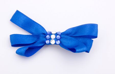 Blue gift satin ribbon bow on white backgroundの写真素材