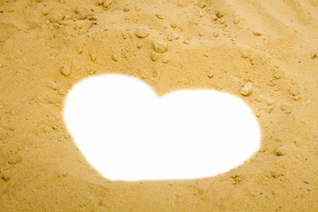 Shape of heart into a sand  の写真素材