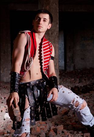 A young guy in a suit on the ruins of an unusualの写真素材