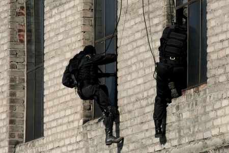 Subdivision anti-terrorist police during a black tactical exercises. Rope Techniques. Real situation.のeditorial素材
