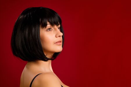 Portrait of sexy brunette on red background in studioの写真素材