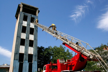 fireman wearing a gas mask on the stairsの写真素材