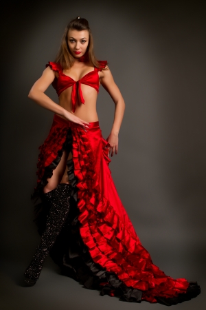Close-up photo of the lady in gypsy costume dancing flamenco  on a gray backgroundの写真素材
