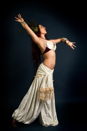 Young attractive retro model in old-fashioned wild clothing dancingの写真素材
