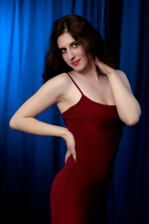 beautiful young brunette portrait shot in studio on dark backgroundの写真素材