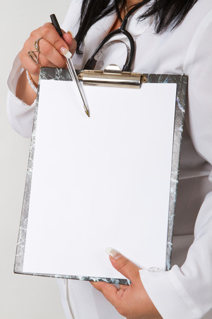 anonymous doctor whit notepad a over white backgroundの写真素材