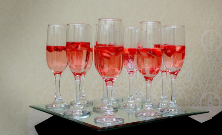 Strawberry splashing into a glass of champagne celebration