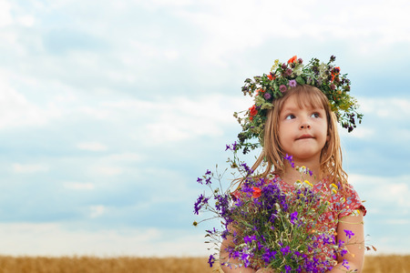 Cute little girl in summer wheat field Girl in a wheat fieldの写真素材