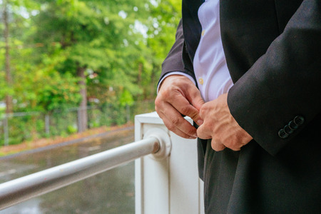 Hands of wedding groom getting ready in suit hand groom bride preparing for the weddingの写真素材