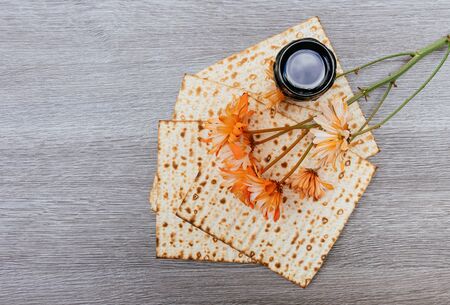 passover background. wine and matzoh over wooden table. vintage effect process.