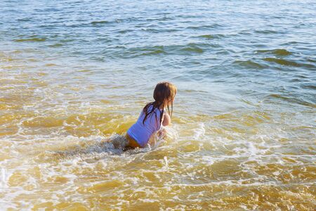 beautiful little swimming in the ocean Happy little girl swimming in the seaの写真素材