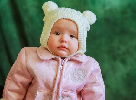 Portrait of cute little smiling girl. Standing against grey background.の写真素材