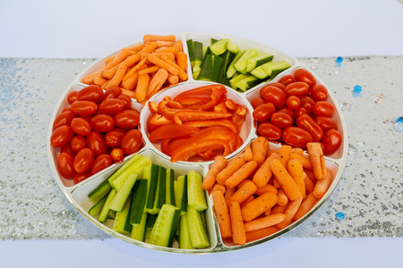 fresh vegetables snack - carrots, sweet pepper, cucumbers and tomatoes carrots tomatoes cucumbers