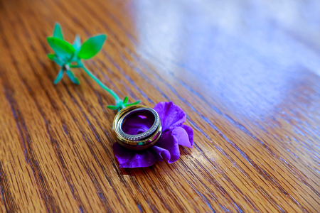 Wedding rings closeup on a pattern background.の写真素材