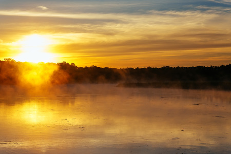 Autumn fog in the morning on the river fog lake sunriseの写真素材