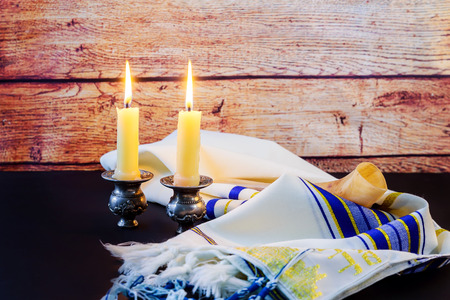 A table set for Shabbat with lighted candles, challah bread and wine.の写真素材