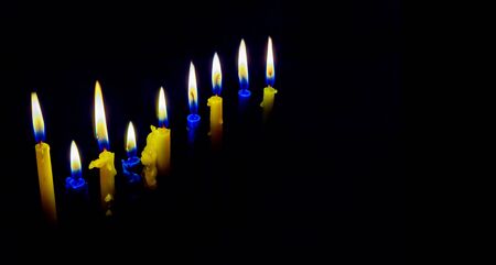 Jewish holiday hannukah low key image of jewish holiday Hanukkah with menorah traditional Candelabra and wooden dreidels spinning top . glitter overlayの写真素材