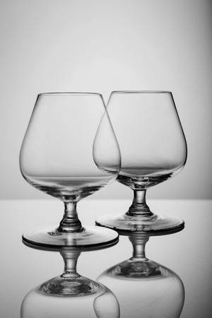 Two empty brandy glasses isolated on white background Empty brandy glassの写真素材