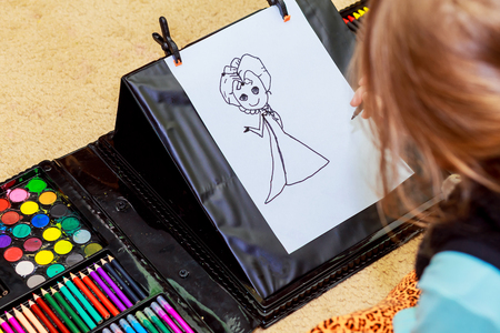 cute girl drawing with colourful pencils little girl draws pencilsの写真素材