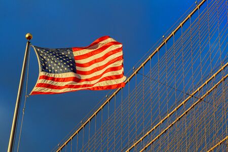 American flag - star and stripes floating over a cloudy blue skyの写真素材