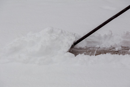 Shoveling snow after a winter storm snow removal shovelの写真素材