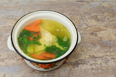 chicken broth carrots chicken green Chicken soup in a bowl with crackers.の写真素材