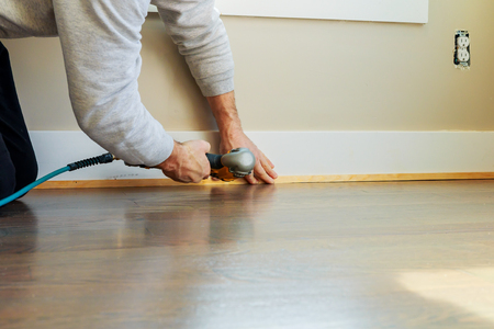 Gauge Finish Nailer man nailed slats custom house building contractor up a wall section for luxury custom houseの写真素材