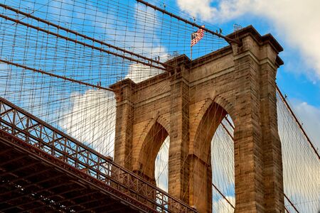 American flag on Brooklyn Bridge Brooklyn bridge with cloudy blue sky, New Yorkの写真素材