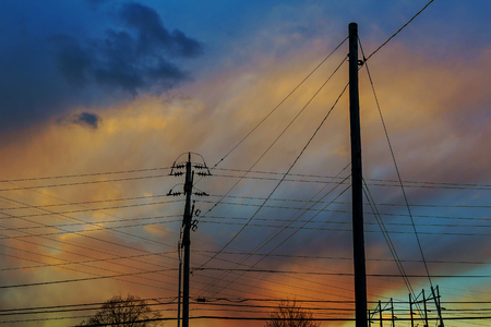 electricity poles at sunset with colorful cloud sunset sky power lineの写真素材