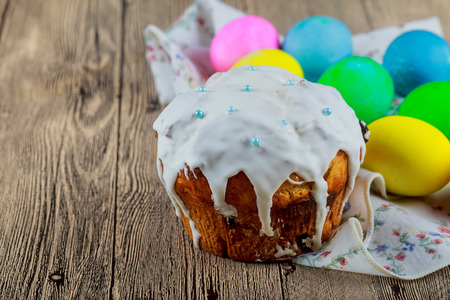 Easter orthodox sweet bread, kulich and colorful quail eggs with white tulips. Holidays breakfast...
