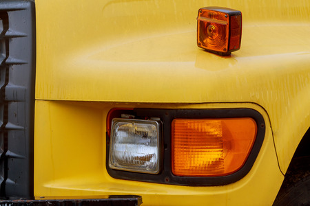 Front end of a semi truck while parked yelow truck