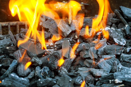 Charcoal briquettes firing up for the grill coal fire