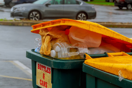 Overflowing garbage bins with household waste in the city dustbin being full with garbage