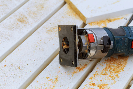variable speed plunge router isolated on sawdust background