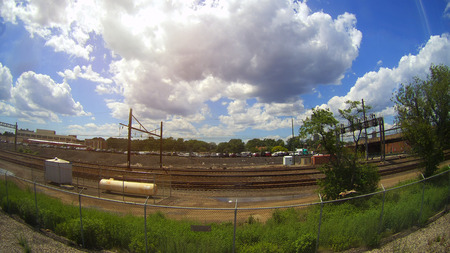 Railroad in motion at sunset. Railway station with motion blur effect against colorful blue sky, Industrial concept background. Railroad travel, railway tourism. Blurred railway. Transportationのeditorial素材