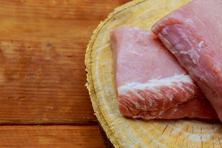 Pieces of pork on a cutting board uncooked pork chops onの写真素材