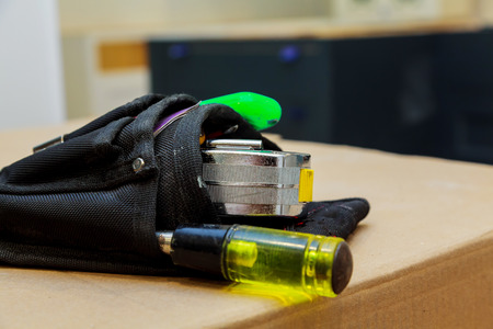 Work tools in bag on wood background. Tool bagの写真素材