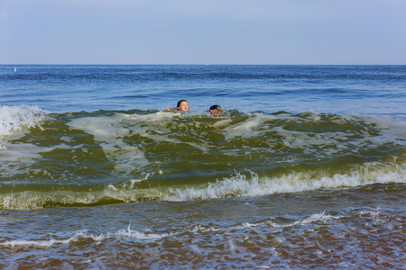 Happy child and father playing in swimming ocean Summer vacation conceptの写真素材