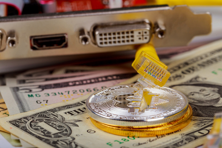Golden ethereum coin cryptocurrency on a computer coin bitcoin dollars graphic card internet wireの写真素材
