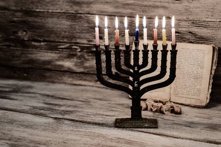 Menorah with candles for Hanukkah against defocused lights, close upの写真素材