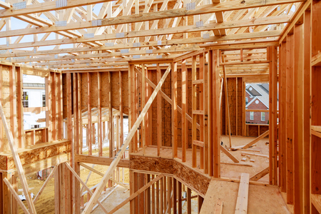 New home construction with wooden house frame building