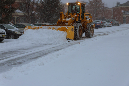 January 04 2018 NY New York: Snow-removing machine cleans the street of the city park from the snow in the morning snow-covered trees. Cleaning road from snow storm.のeditorial素材
