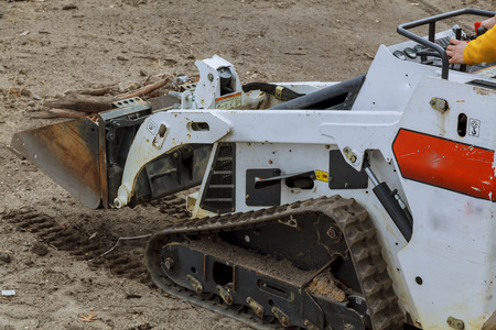 Skid loader on construction site small excavator Bobcat at construction site