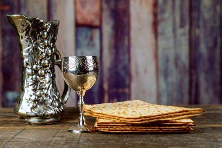 Matzo for Passover with metal tray and wine on table