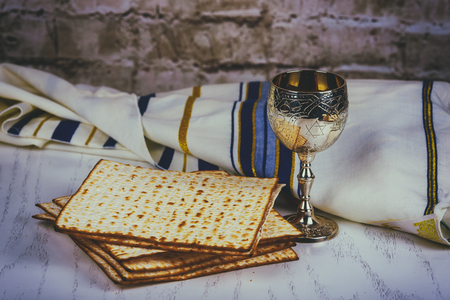 Pesach Passover symbols of great Jewish holiday. Traditional matzoh, matzah or matzo and wine in...
