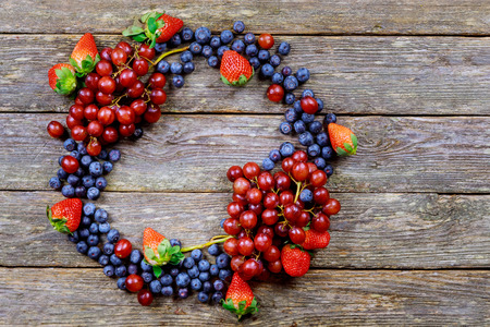 summer fruits on a wooden table. Blueberries Grape Strawberries Organic Healthy Productsの写真素材